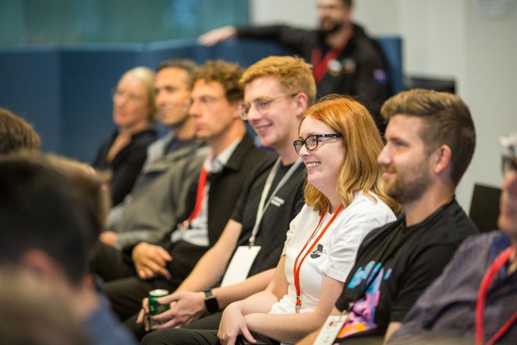 A group of young men and women watching a presentation