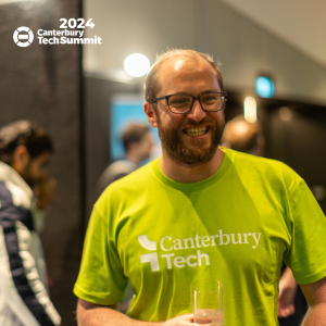 Henry, our membership and events coordinator, wearing the new logo t-shirt at tech Summit 2024