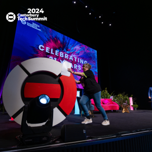 Louisa Taylor pushes the old logo off the stage afterannouncing the new 2024 brand.